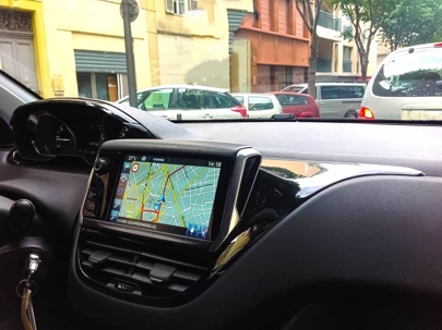 Close up of an infotainment system in a car while driving on the street during the day