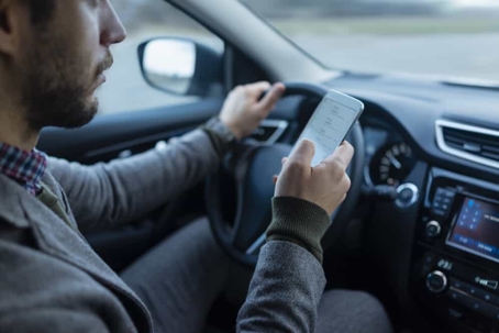 Man uses cell phone while driving