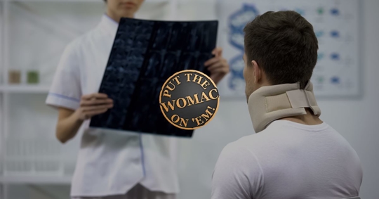 doctor explaining x ray to injured neck patient